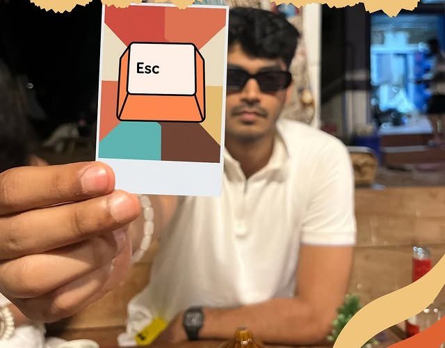 A member holding the Escapeer 'Esc' key card